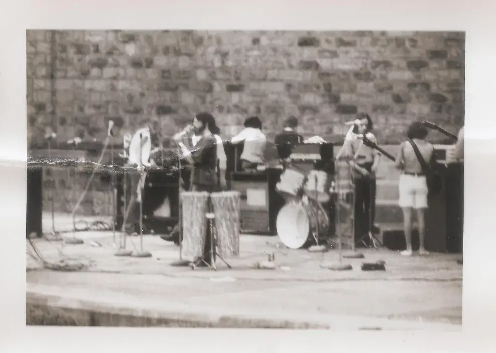 Greg Falvo at the microphone on the outdoor stage at Roxbury Park, 1971